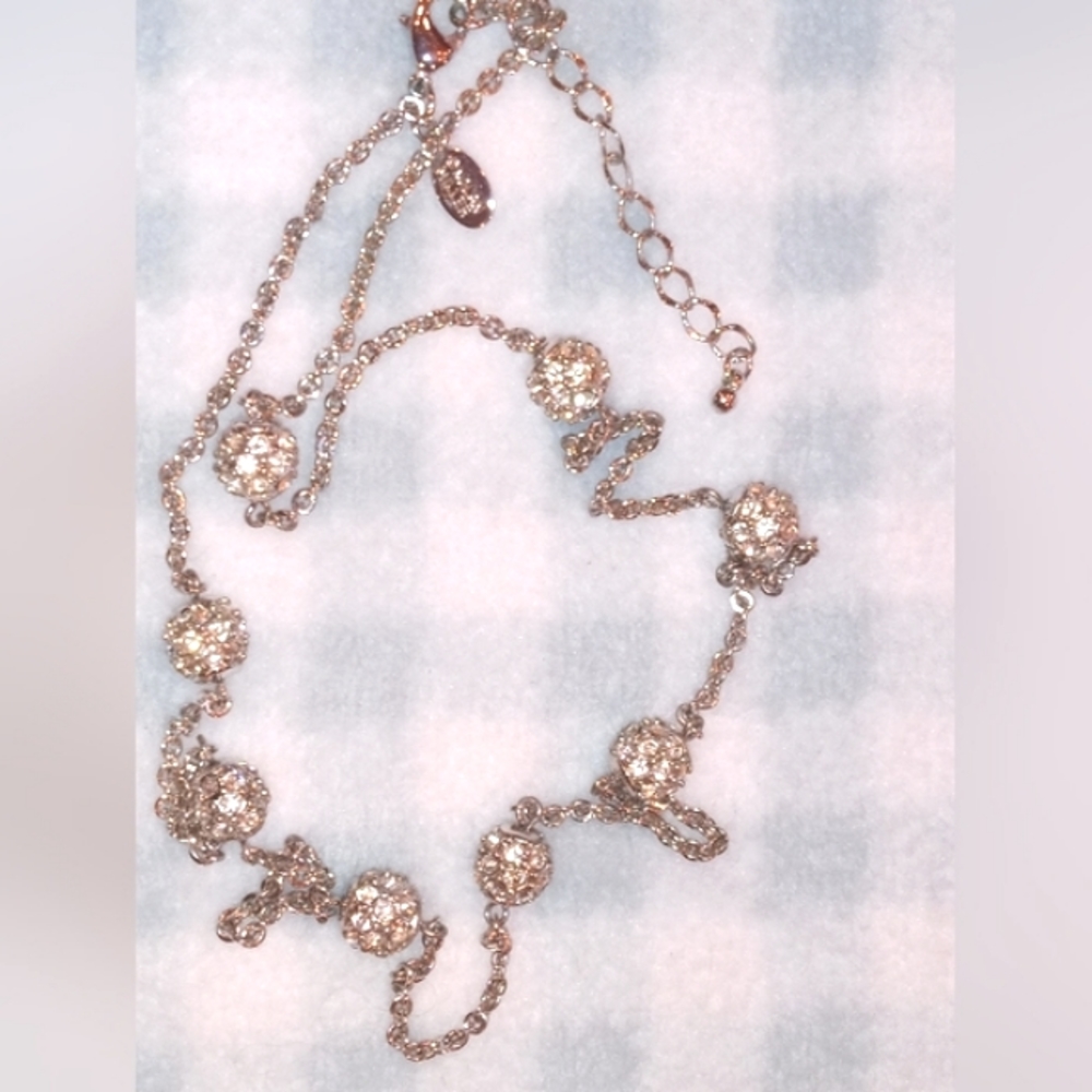 Nolan Miller necklace adjusts from 24 down to 22 inches. Chain and rinestones